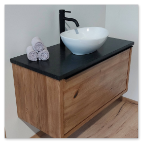 Waschtisch-Kombination aus dunkler Granitplatte, Holz-Unterschrank und weißem Aufsatzwaschbecken.